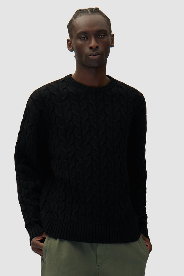 Arte Knit Sweater in Black worn by a model, half-body front view