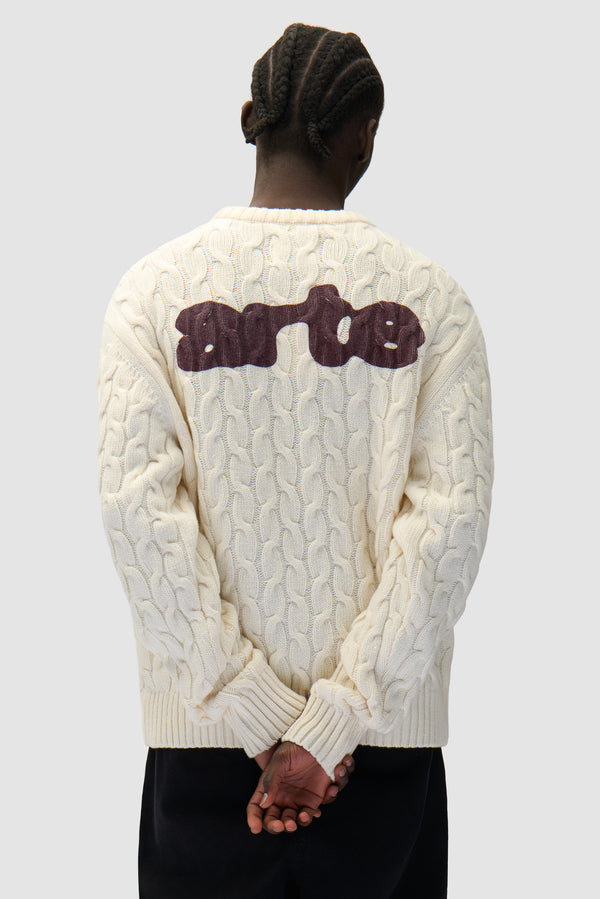 Arte Knit Sweater in Cream worn by a model, half-body back view
