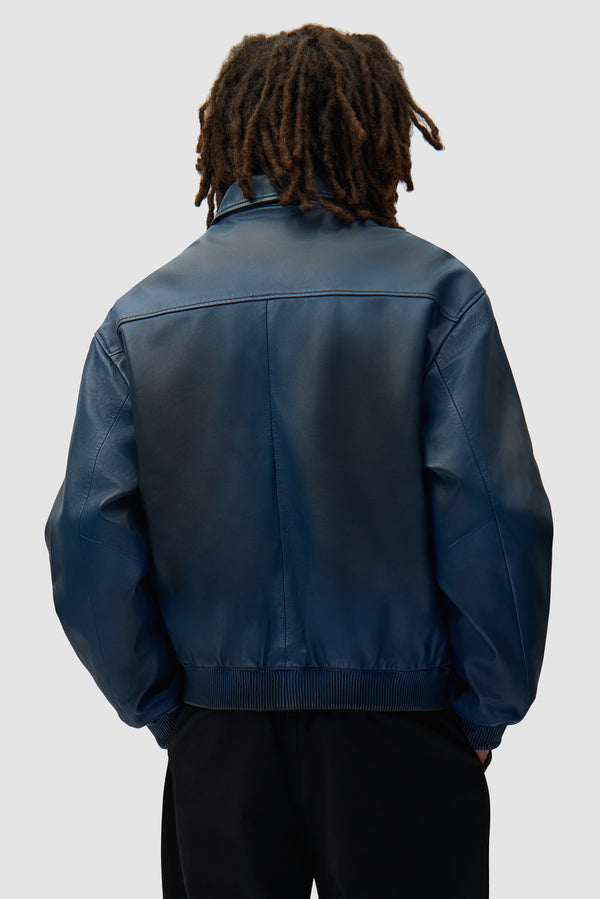 Leather Fade Jacket in Navy worn by a model, half-body back view