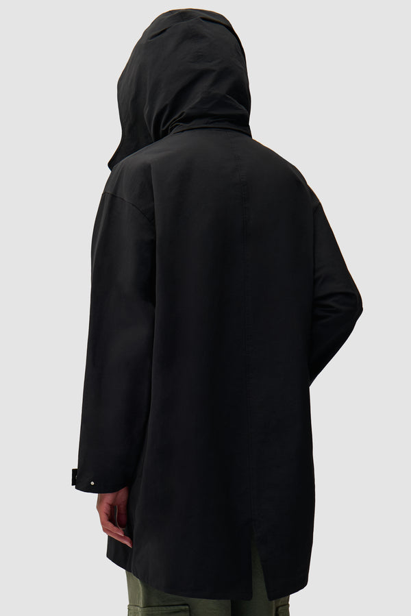 Black Coat in Black worn by a model, half-body back view