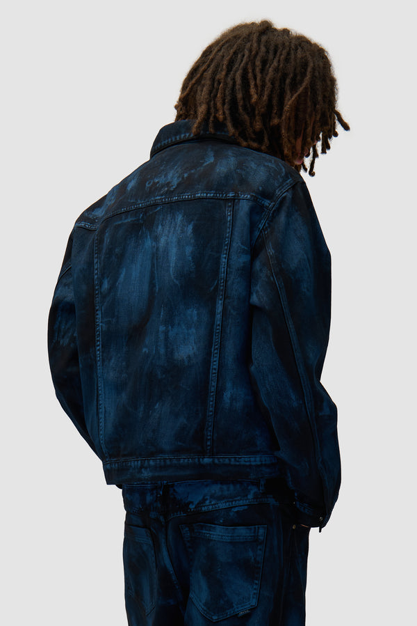 Paint Jacket in Black worn by a model, half-body back view