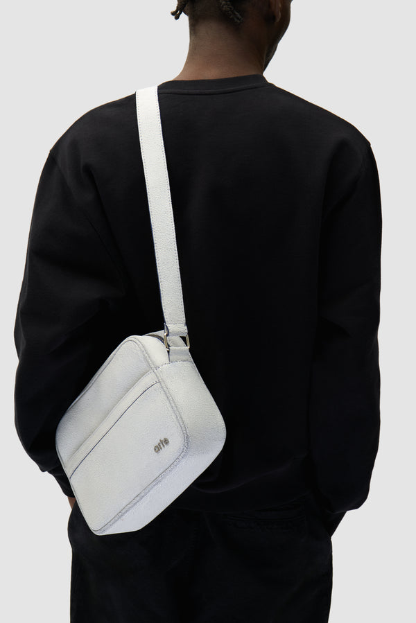 Cracked Leather Side Bag in White worn by a model, half-body view