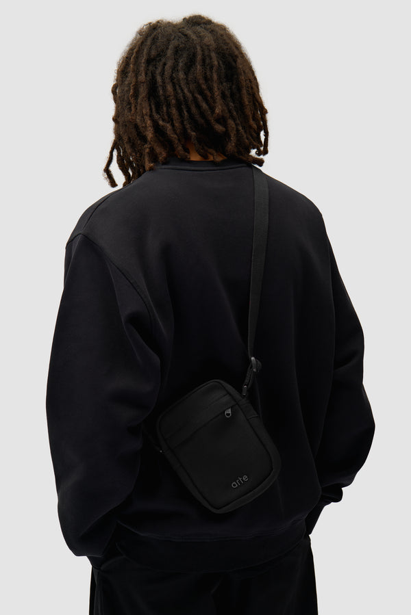 Ribstop Bag in Black worn by a model, half-body view
