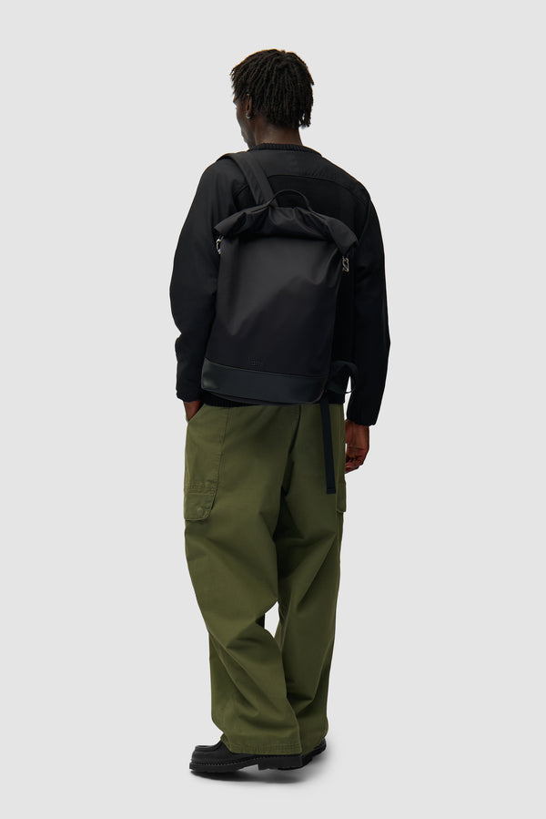 Folding Backpack in Black worn by a model, half-body back view