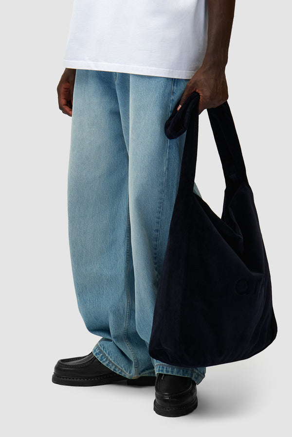 Corduroy Body Bag in Navy worn by a model, half-body view
