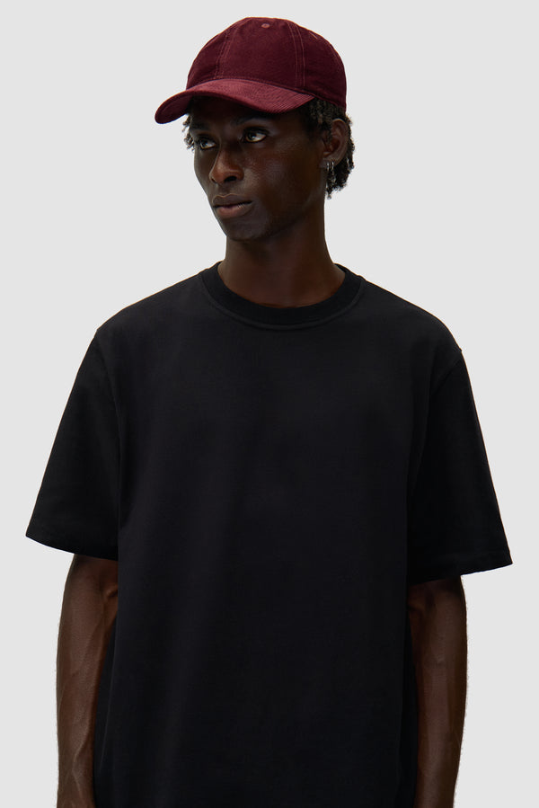 Corduroy Cap in Bordeaux worn by a model, half-body front view
