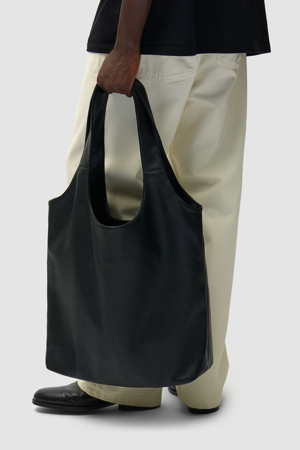 Leather Bag in Black worn by a model, half-body view