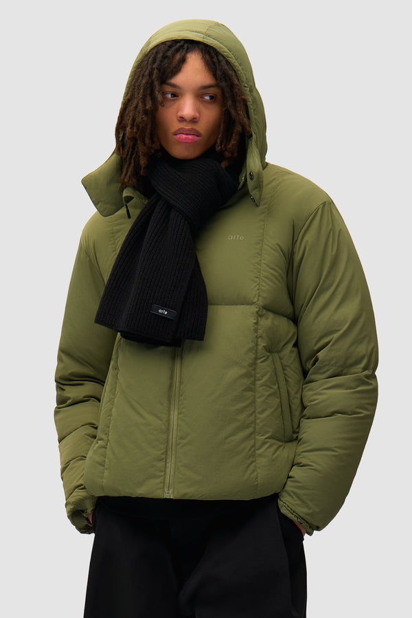 Label Scarf in Black worn by a model, half-body front view