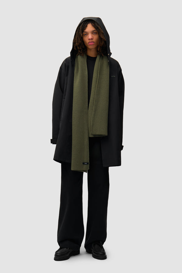Label Scarf in Dark Green worn by a model, half-body front view