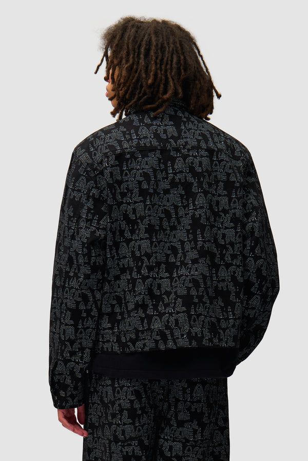 Allover Arte Jacket in Black worn by a model, half-body back view