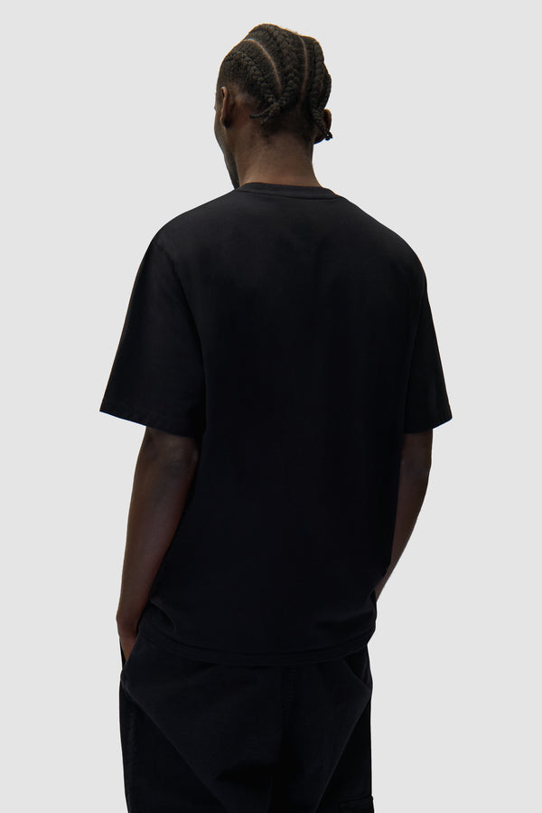 Arte Pixel T-shirt in Black worn by a model, half-body back view