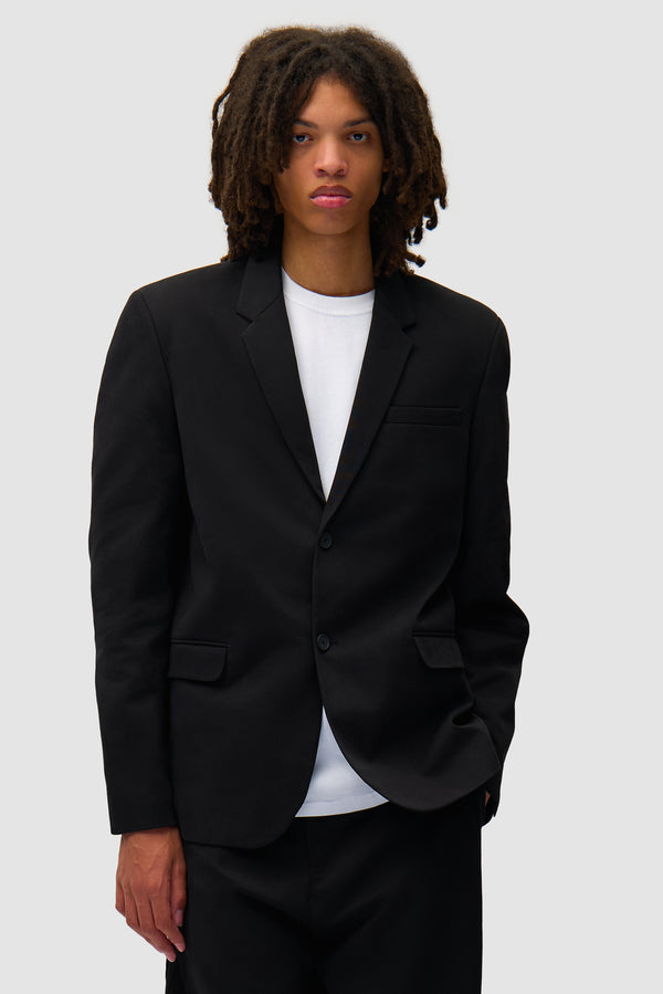 Suit Blazer in Black worn by a model, half-body front view