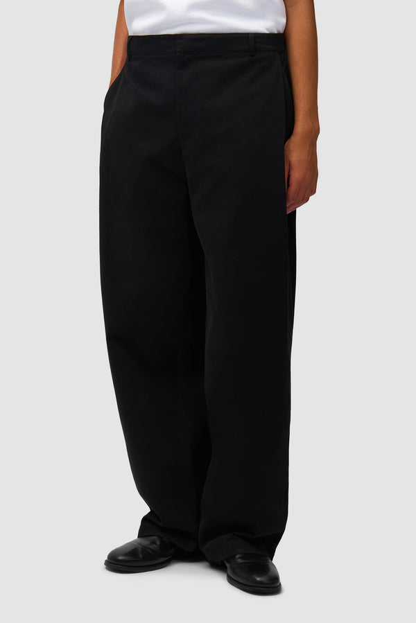 Dress Pants in Black worn by a model, half-body back view