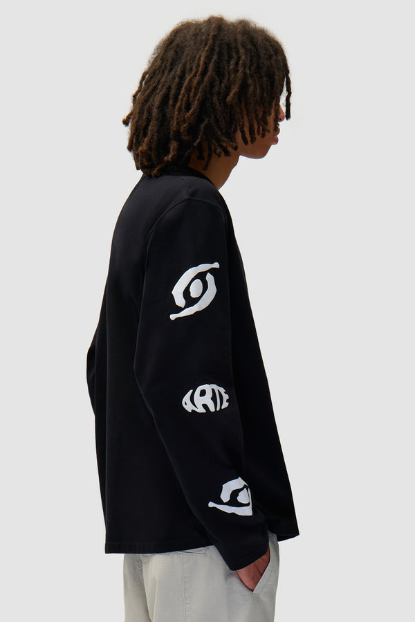 Eye Sleeve Longsleeve in Black worn by a model, half-body back view