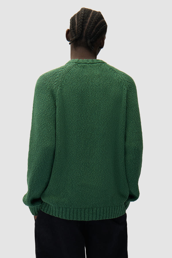 Pixel Front Knit in Green worn by a model, half-body back view