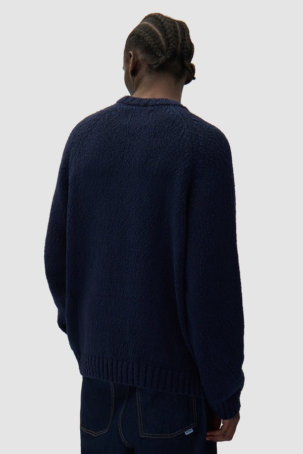 Pixel Front Knit in Navy worn by a model, half-body back view