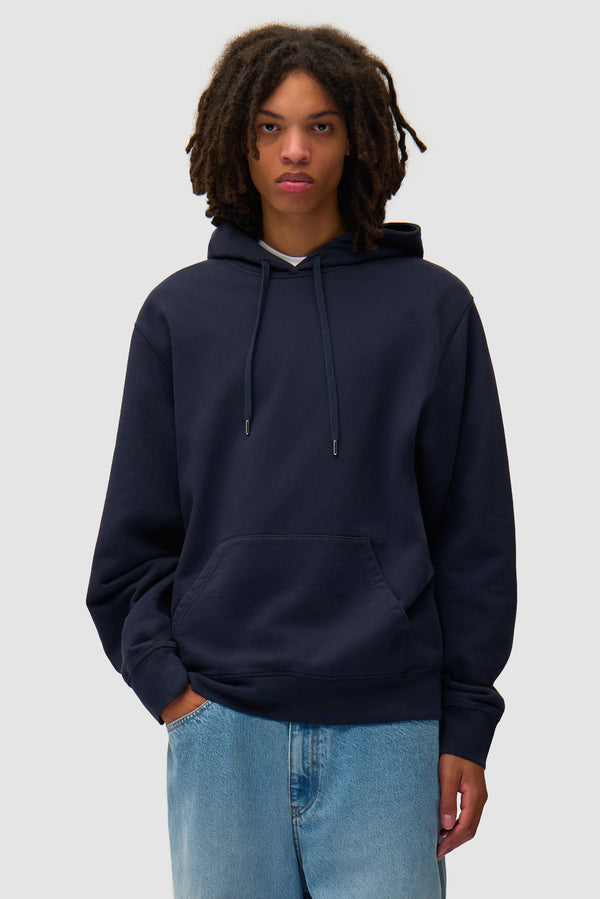 Arte Together Hoodie in Navy worn by a model, half-body front view