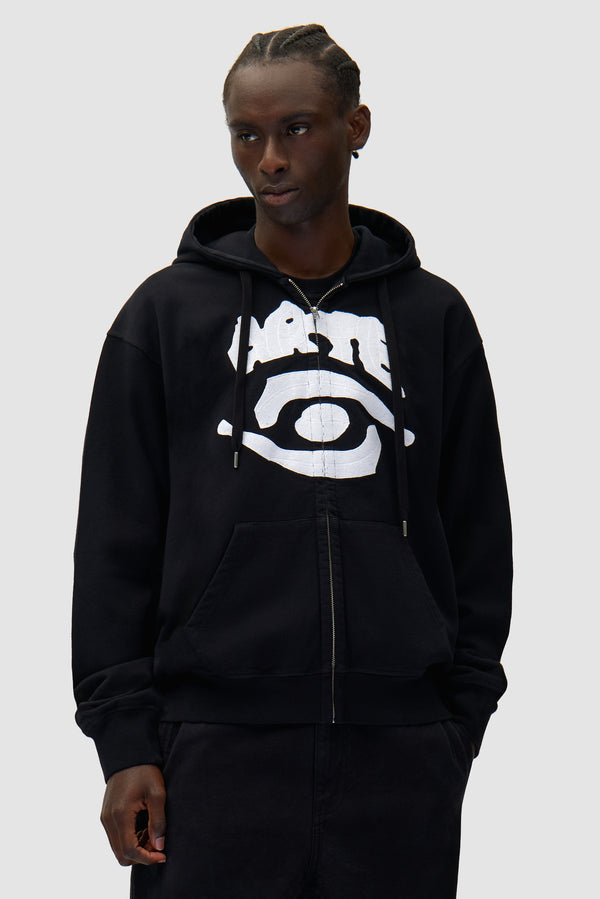 Eye Front Zip Hoodie in Black worn by a model, half-body front view