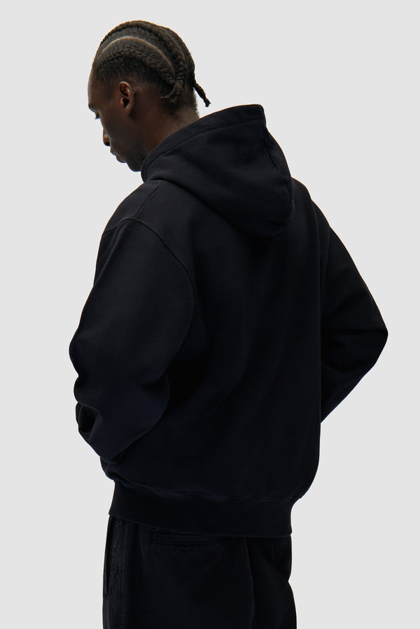 Eye Front Zip Hoodie in Black worn by a model, half-body back view