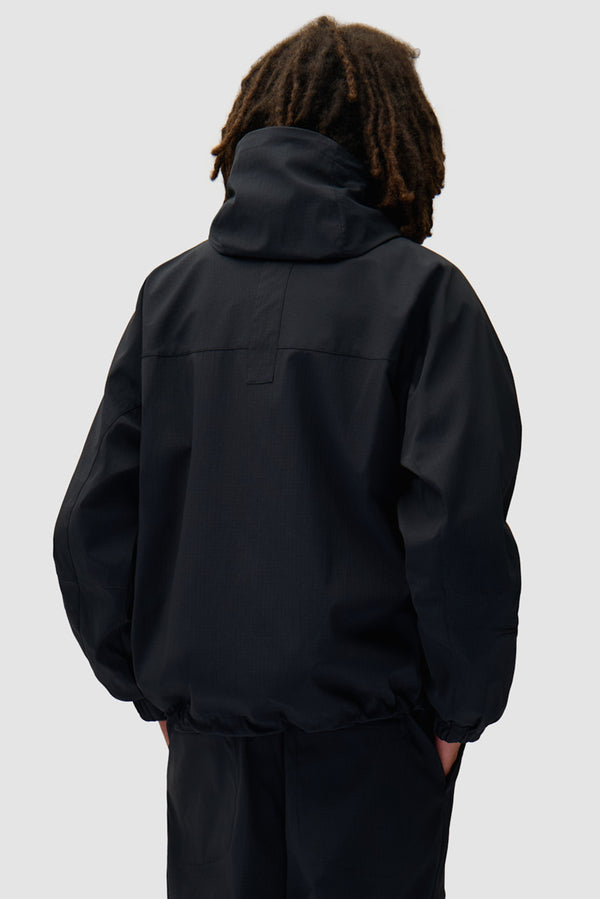 Technical Polar Jacket in Black worn by a model, half-body back view