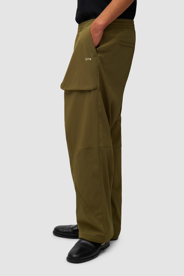 Technical Polar Pants in Green worn by a model, half-body side view