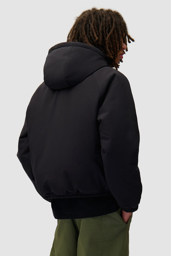 Nylon Reversible Jacket in Black worn by a model, half-body back view
