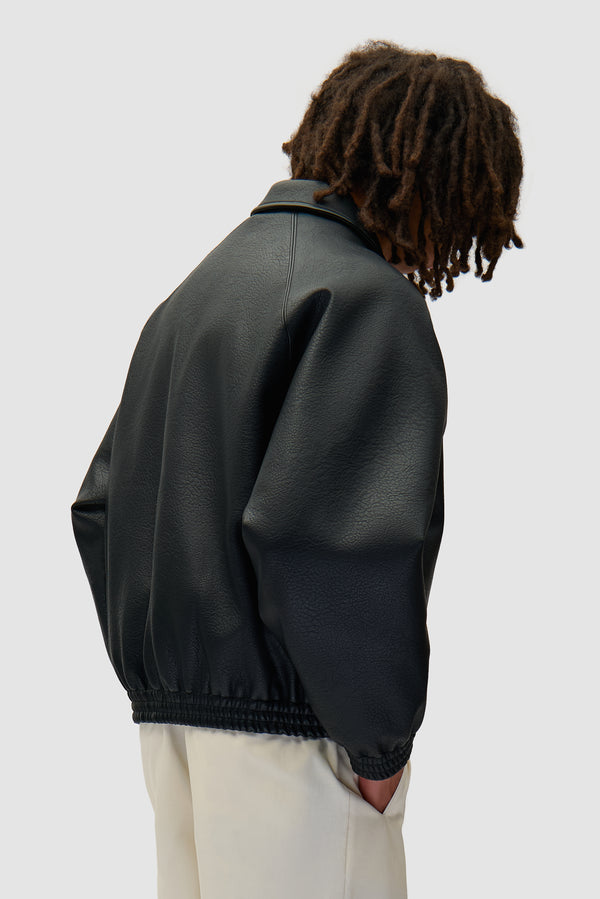 Basic Leather Jacket in Black worn by a model, half-body back view