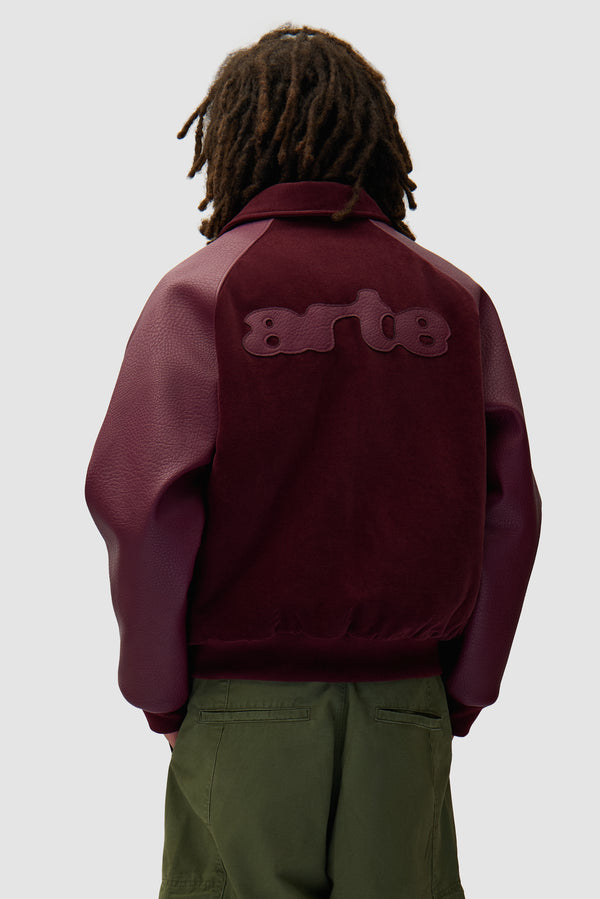 Varsity Jacket in Bordeaux worn by a model, half-body back view