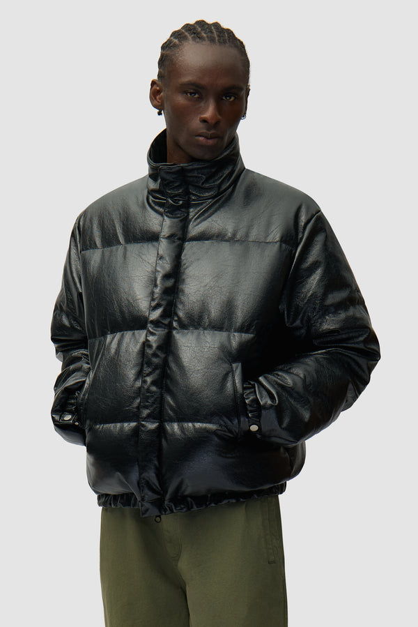 High Collar Puffer Jacket in Black worn by a model, half-body front view