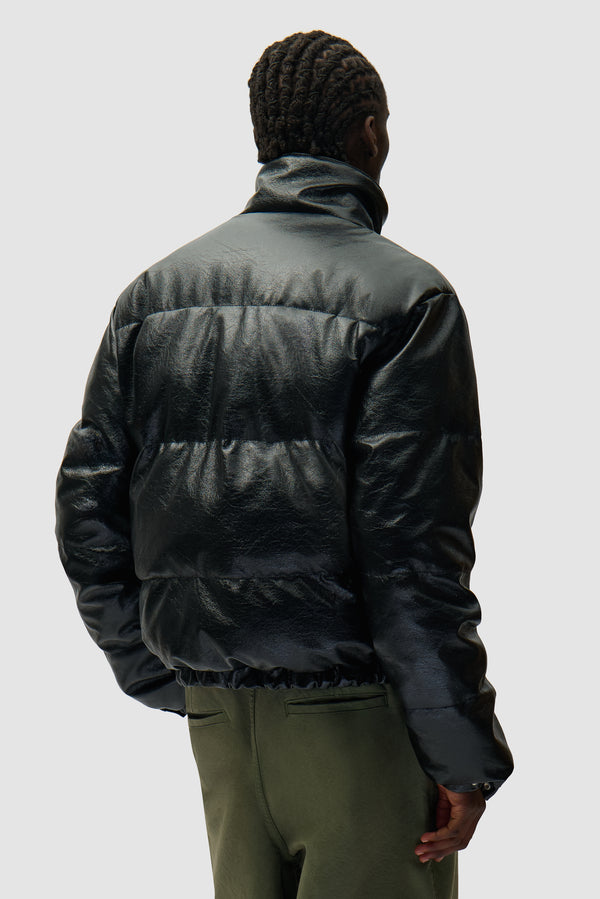 High Collar Puffer Jacket in Black worn by a model, half-body back view
