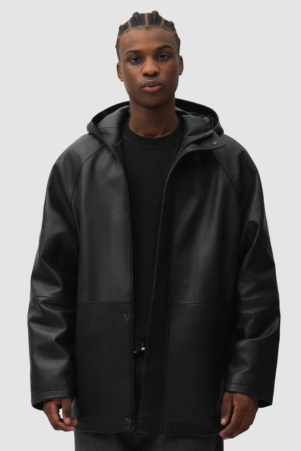Leather Rain Coat in Black worn by a model, half-body front view