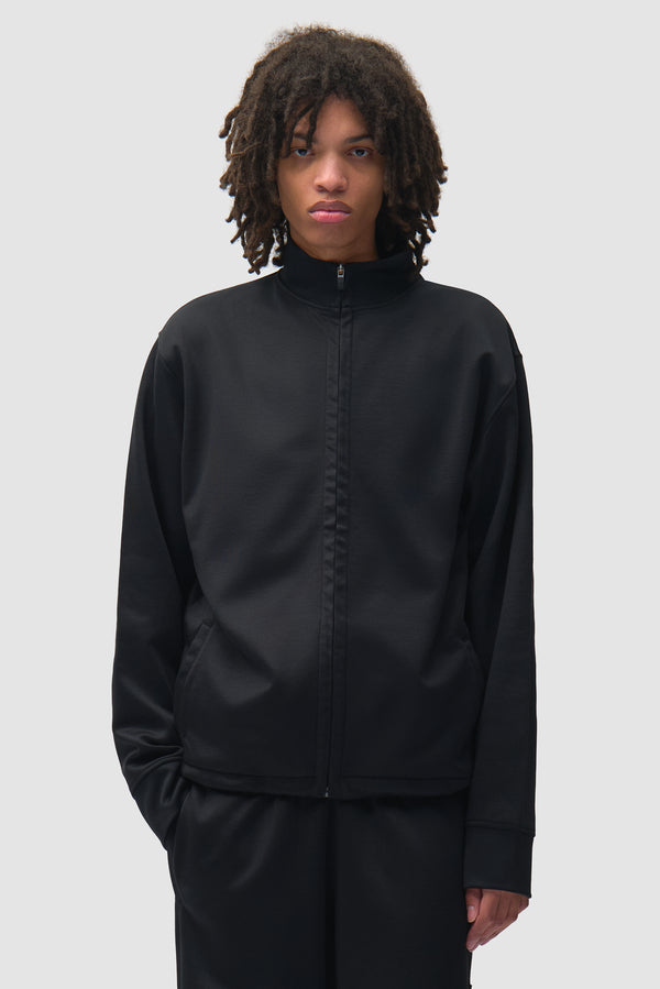 Polyform Nylon Track Jacket in Black worn by a model, half-body back view
