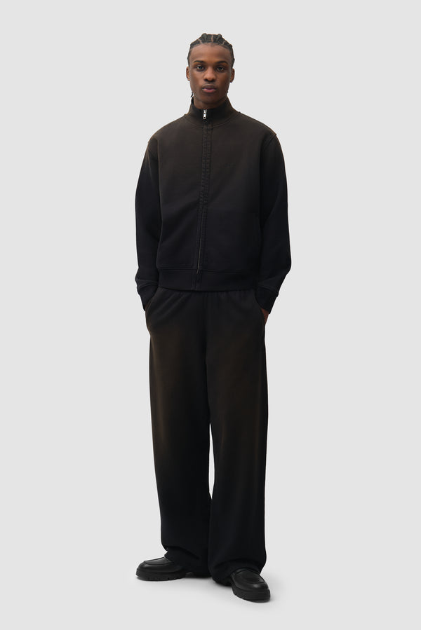 Sunfade Uniform Track Jacket in Black worn by a model, full-body front view