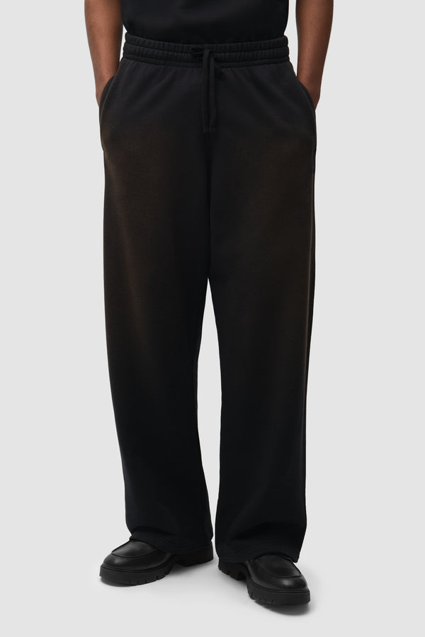 Sunfade Uniform Track Pants in Black worn by a model, half-body front view