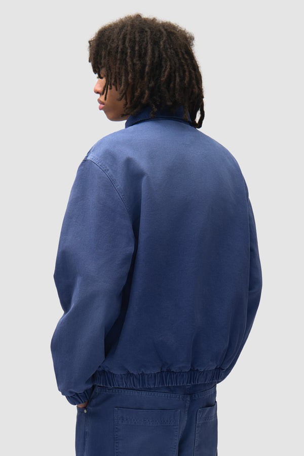 Arc Denim Jacket in Blue worn by a model, half-body side view