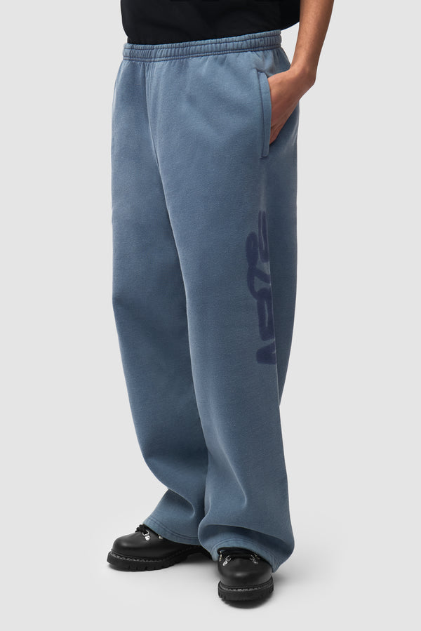 Sunfade Stencil Ease Sweatpants in Navy worn by a model, half-body back view