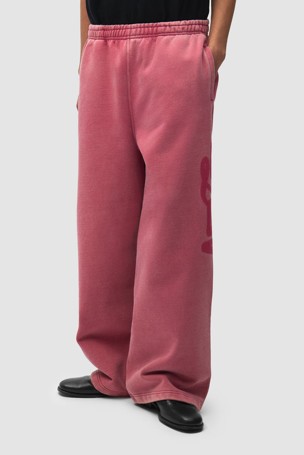 Sunfade Stencil Ease Sweatpants in Red worn by a model, half-body back view