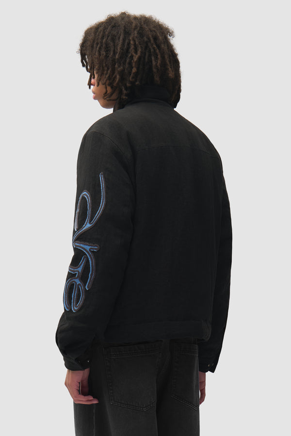 Swirl Utility Jacket in Black worn by a model, half-body back view