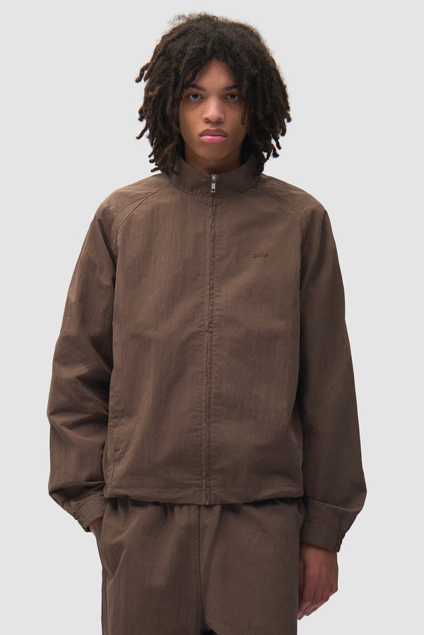 Uniform Track Jacket in Brown worn by a model, half-body front view