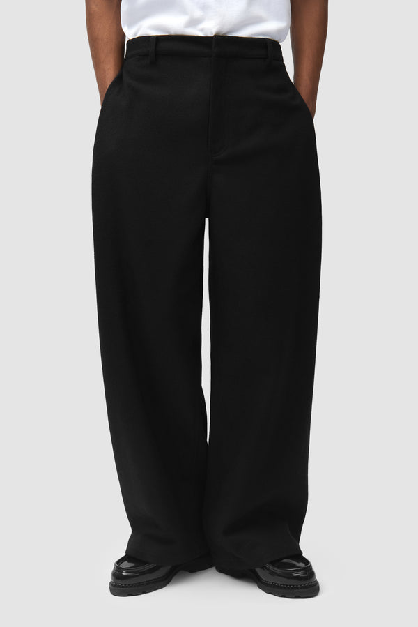 Wool Pleated Gallery Pants in Black worn by a model, half-body front view