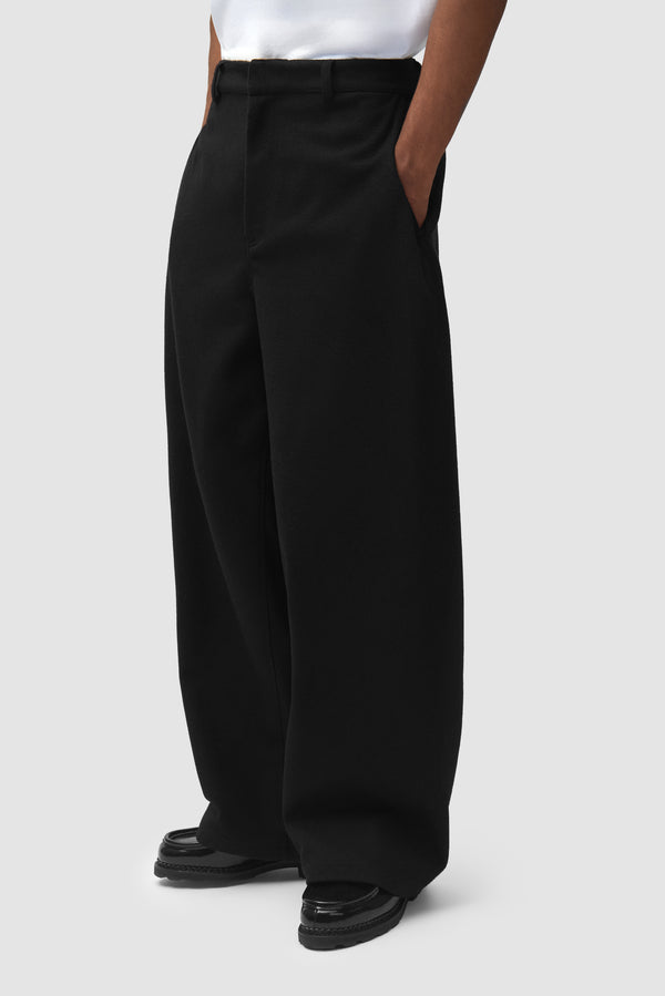 Wool Pleated Gallery Pants in Black worn by a model, half-body front view