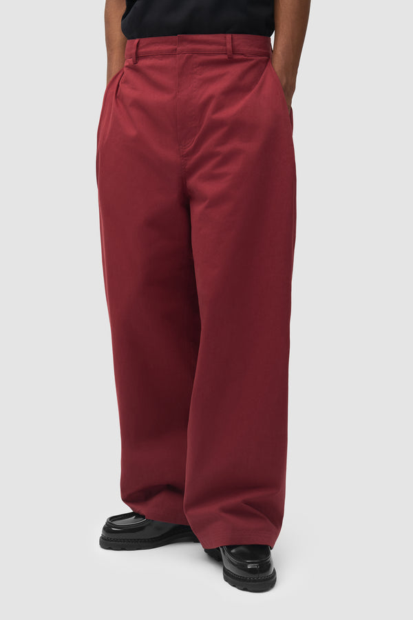 Pleated Gallery Pants in Bordeaux worn by a model, half-body front view