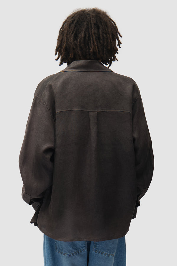 Dusty Linen Zip Shirt in Black worn by a model, half-body back view