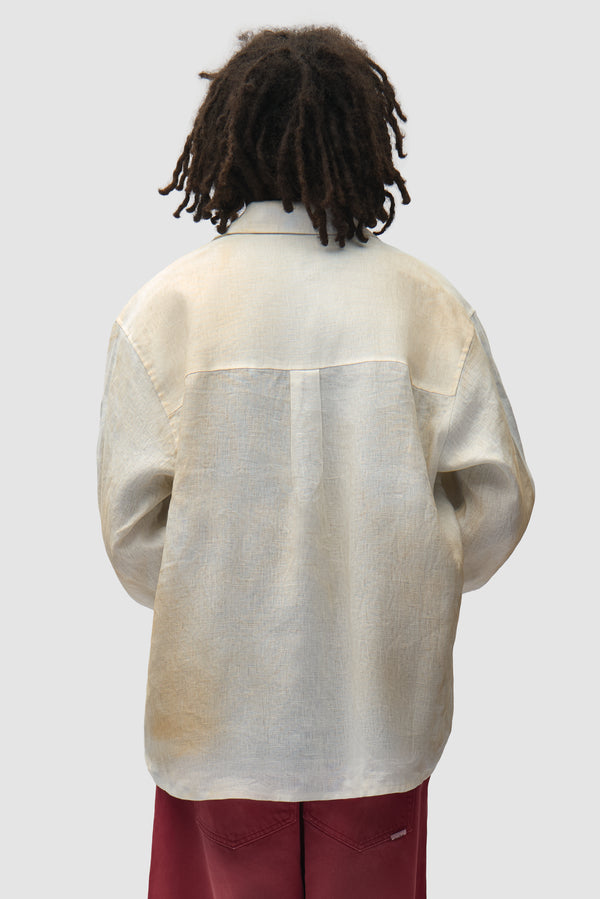 Dusty Linen Zip Shirt in Cream worn by a model, half-body back view