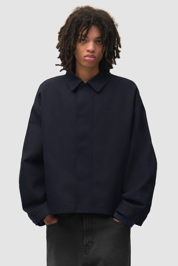 Canvas Atelier Jacket in Navy worn by a model, half-body front view
