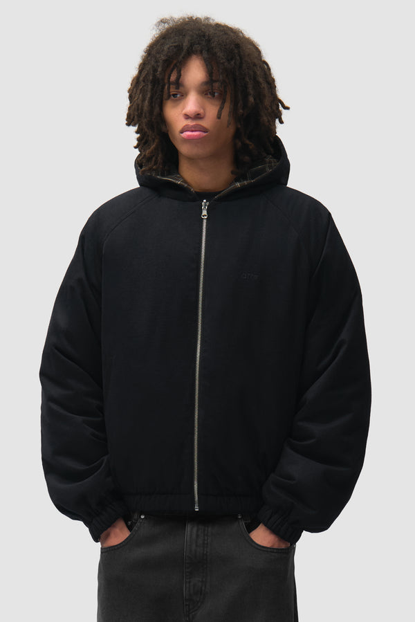 Reversible Plaid Hooded Jacket in Black worn by a model, half-body front view