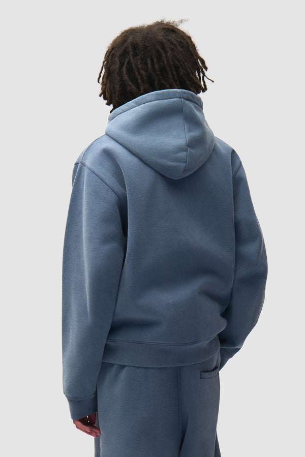 Stencil Sunfade Zip Hoodie in Navy worn by a model, half-body back view