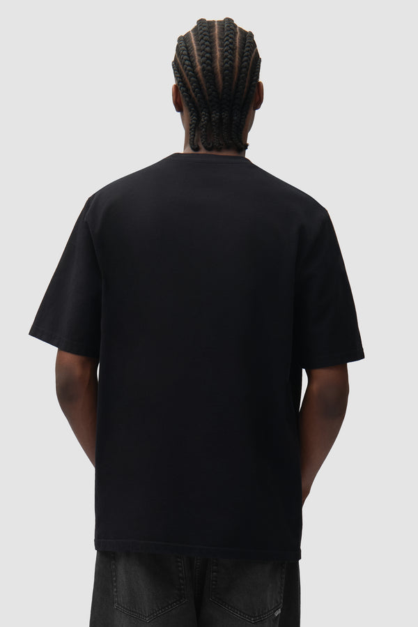 Cor T-shirt in Black worn by a model, half-body back view