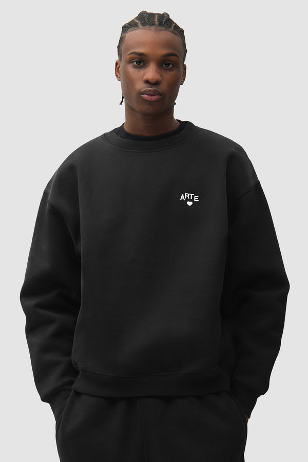 Cor Crewneck in Black worn by a model, half-body front view