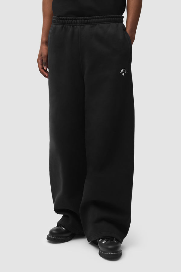 Cor Sweatpants in Black worn by a model, half-body front view